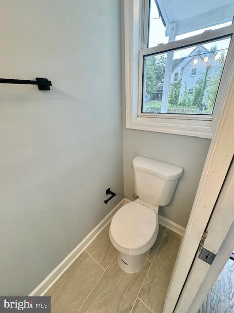 bathroom featuring toilet and tile patterned flooring