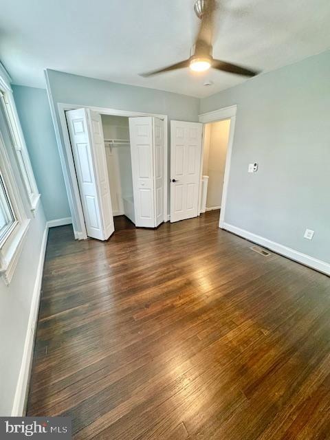 unfurnished bedroom featuring dark hardwood / wood-style flooring and ceiling fan