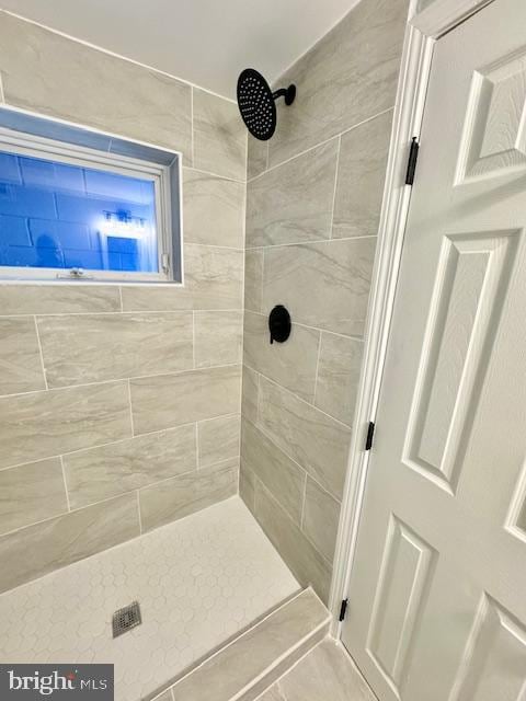 bathroom with a tile shower