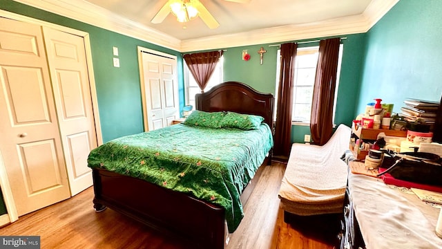 bedroom with ceiling fan, ornamental molding, and wood-type flooring