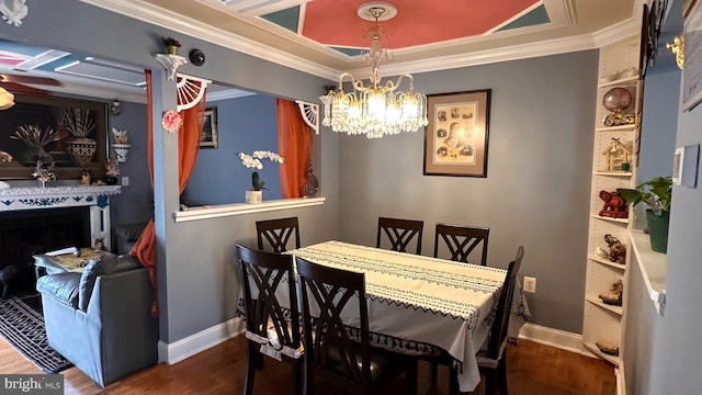 dining room featuring an inviting chandelier, hardwood / wood-style flooring, and crown molding