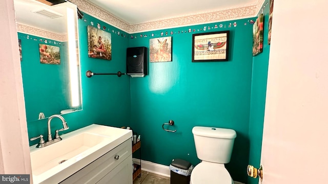 bathroom featuring vanity and toilet