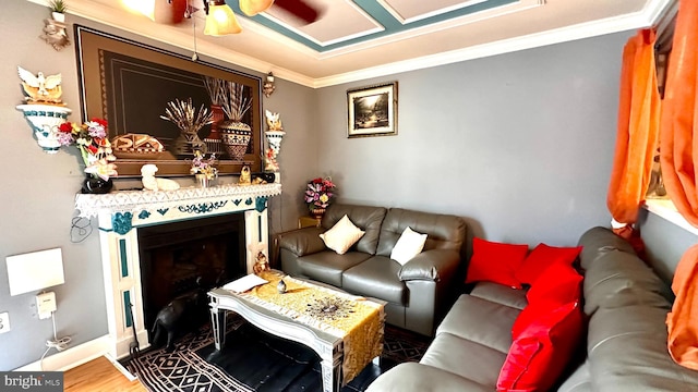 living room featuring wood-type flooring, ceiling fan, and crown molding