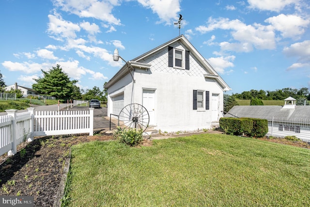 back of property featuring a yard and a garage