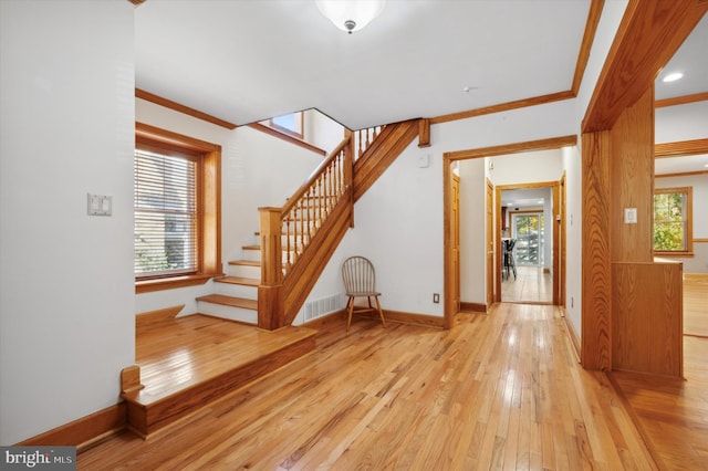 interior space featuring hardwood / wood-style floors and crown molding