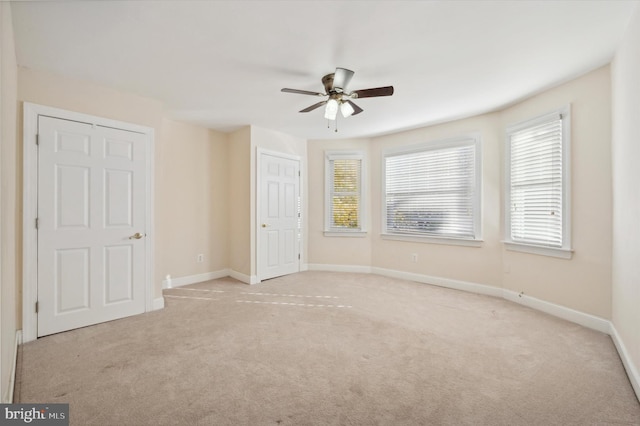 empty room featuring light carpet and ceiling fan