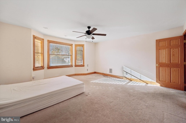 unfurnished bedroom featuring ceiling fan and carpet flooring