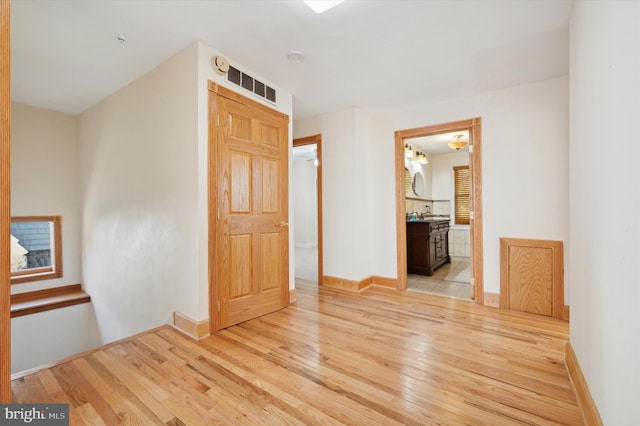 hall with light wood-type flooring