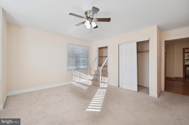 unfurnished bedroom with light colored carpet and ceiling fan