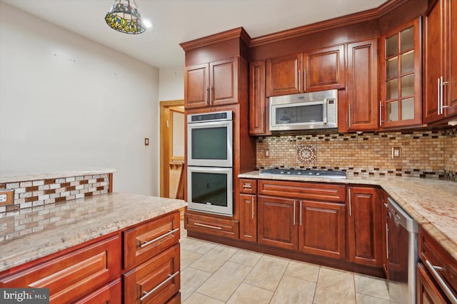 kitchen with decorative backsplash, light stone counters, light tile patterned floors, and stainless steel appliances