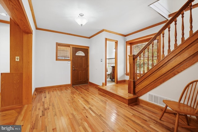 entryway featuring light hardwood / wood-style flooring and crown molding