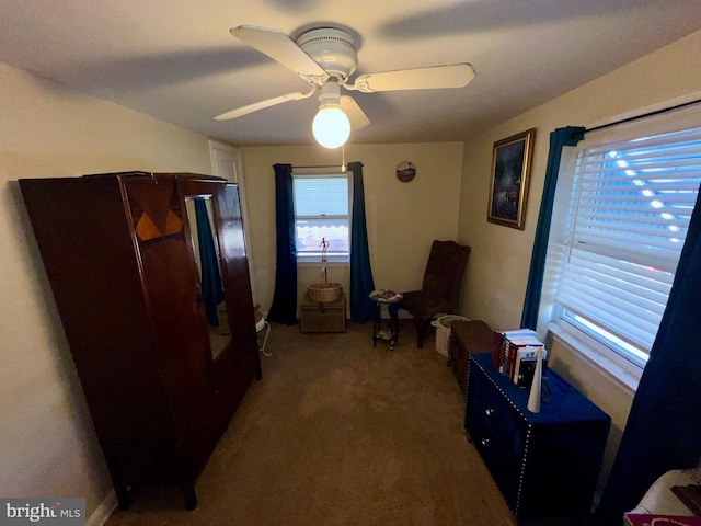 living area with ceiling fan and carpet floors