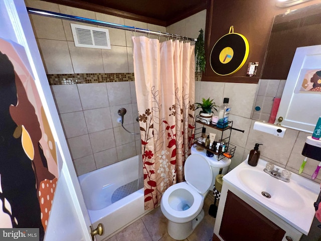 full bathroom featuring shower / tub combo, toilet, tile patterned floors, tile walls, and vanity