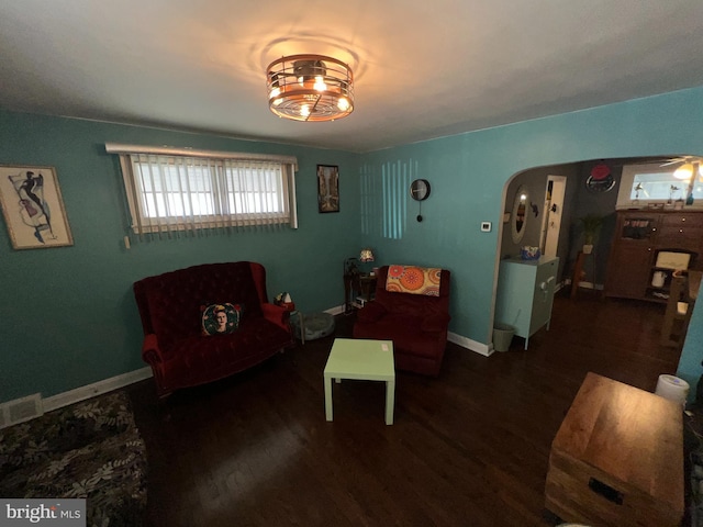 sitting room with dark hardwood / wood-style floors and ceiling fan