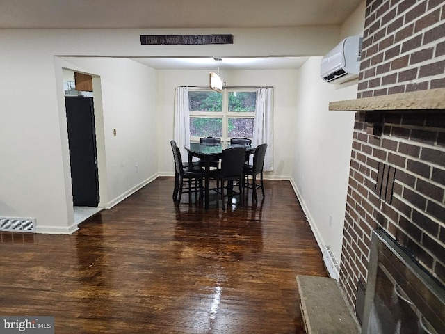 dining area featuring a fireplace, dark hardwood / wood-style flooring, and an AC wall unit