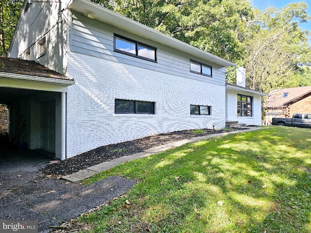 view of side of home with a yard