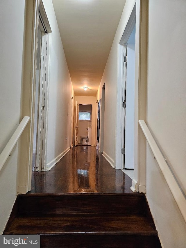 hall with hardwood / wood-style floors