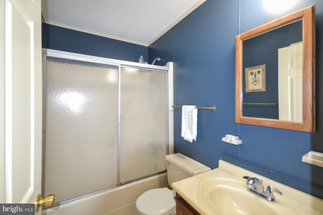 full bathroom with a textured ceiling, combined bath / shower with glass door, crown molding, vanity, and toilet