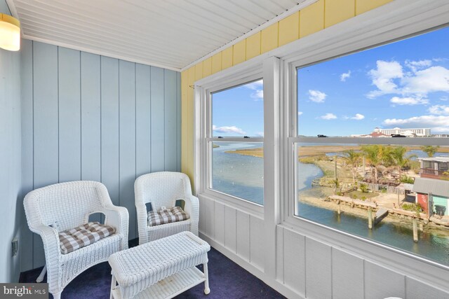 sunroom / solarium with a water view