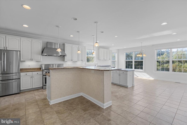 kitchen with a kitchen island, decorative light fixtures, wall chimney exhaust hood, white cabinetry, and stainless steel appliances