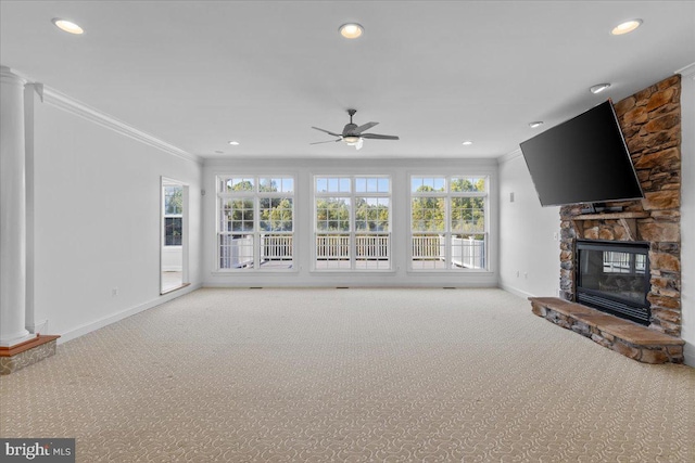 unfurnished living room with carpet flooring, ceiling fan, a fireplace, and crown molding