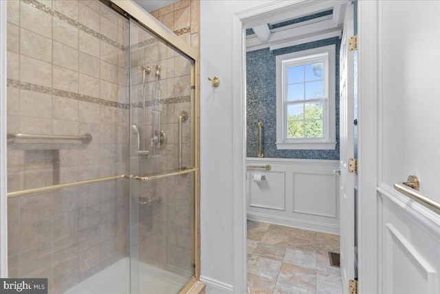 bathroom with a shower with door