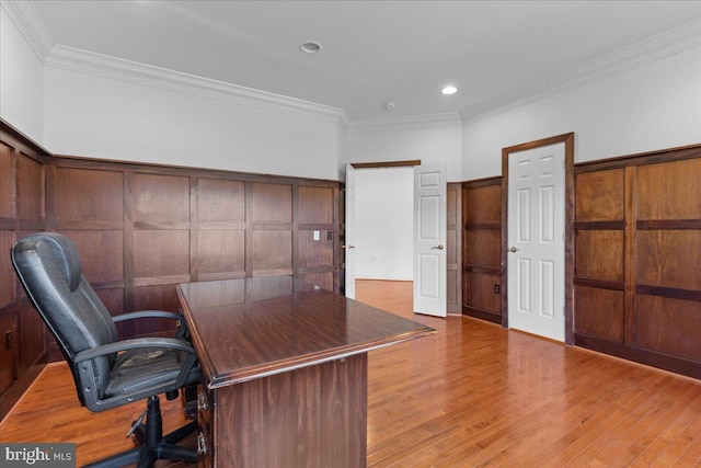 unfurnished office featuring light wood-type flooring and ornamental molding