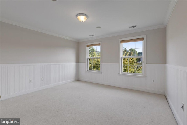 carpeted spare room with crown molding