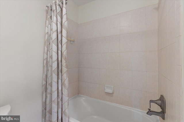 bathroom with shower / tub combo with curtain