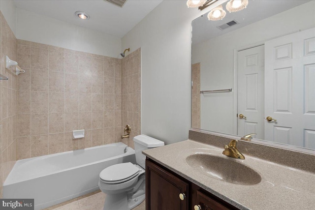 full bathroom featuring vanity, tile patterned flooring, tiled shower / bath, and toilet