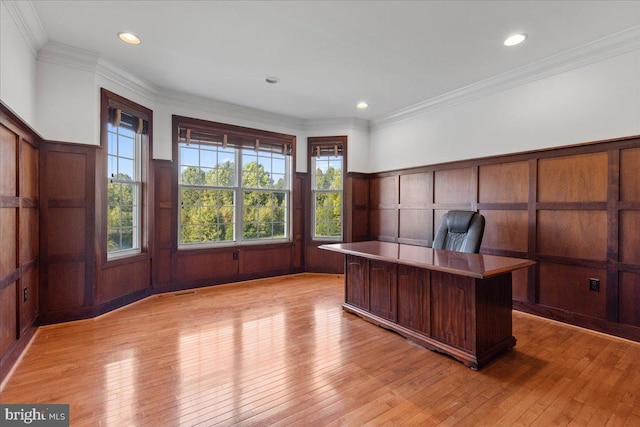 unfurnished office with light wood-type flooring and crown molding