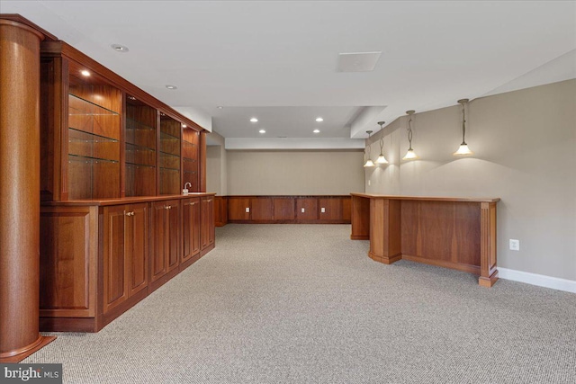 interior space featuring light carpet and pendant lighting