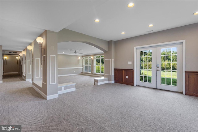 interior space with ceiling fan, light colored carpet, and french doors