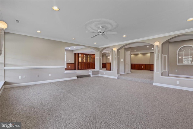 unfurnished living room with ceiling fan, crown molding, and light carpet