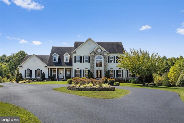 colonial home with a front lawn