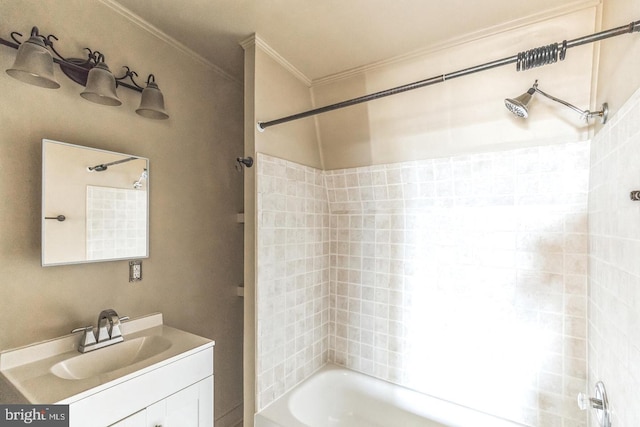 bathroom with vanity, tiled shower / bath, and crown molding