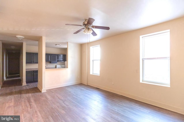 unfurnished living room featuring dark hardwood / wood-style floors and ceiling fan