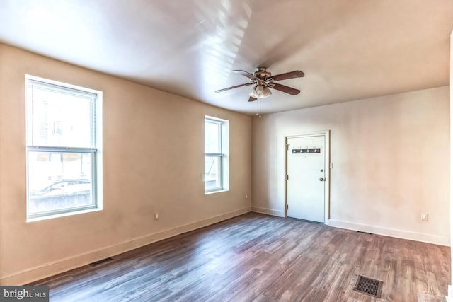 empty room with ceiling fan and hardwood / wood-style flooring