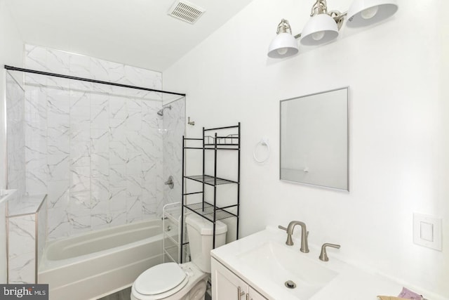 full bathroom with tiled shower / bath, vanity, and toilet