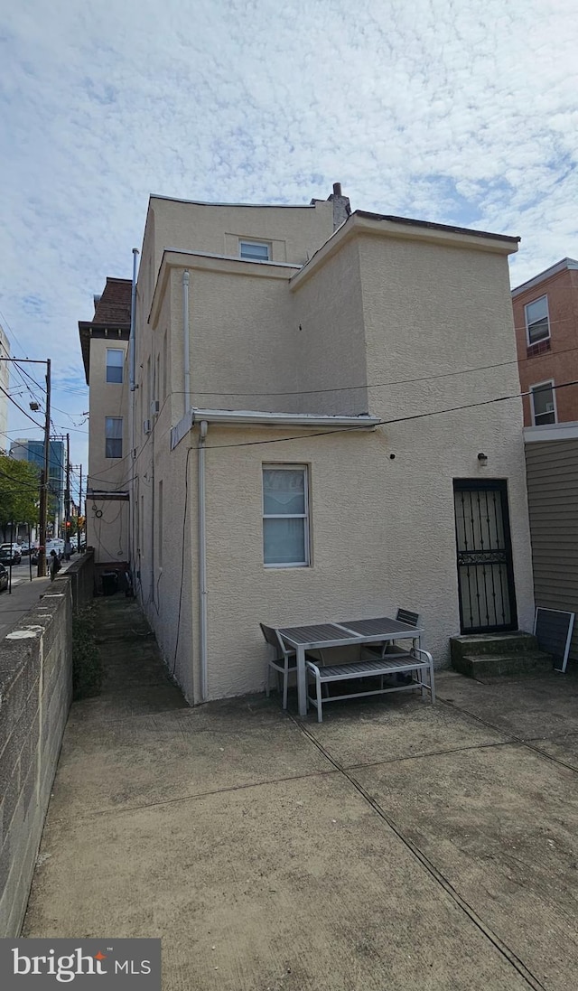 back of house with a patio