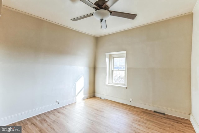 unfurnished room with light hardwood / wood-style floors, ceiling fan, and crown molding