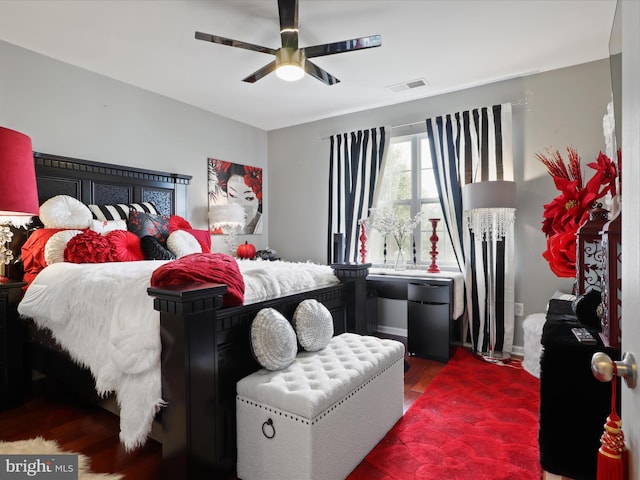 bedroom with dark hardwood / wood-style floors and ceiling fan