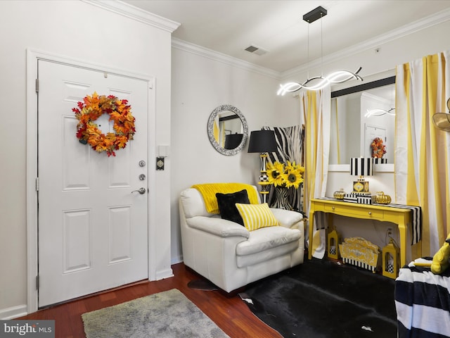 entrance foyer featuring ornamental molding and dark hardwood / wood-style flooring