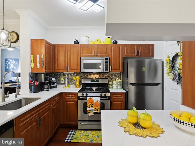 kitchen with sink, decorative light fixtures, stainless steel appliances, crown molding, and decorative backsplash