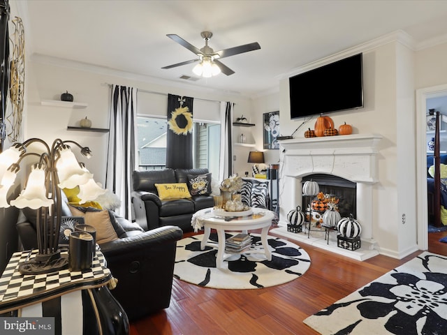 living room with ornamental molding, ceiling fan, and hardwood / wood-style flooring