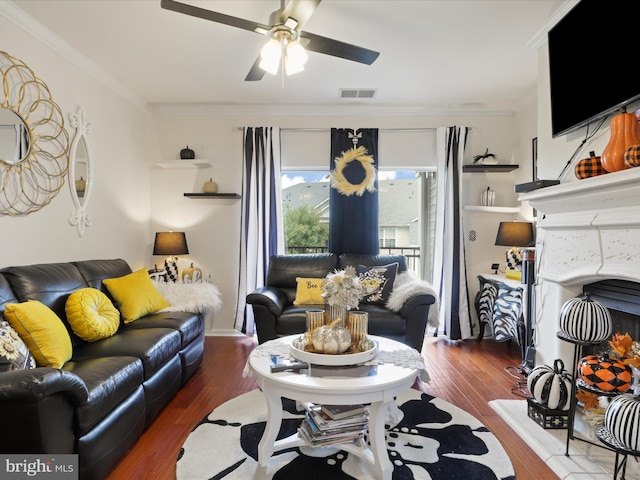 living room with ornamental molding, ceiling fan, and dark hardwood / wood-style flooring