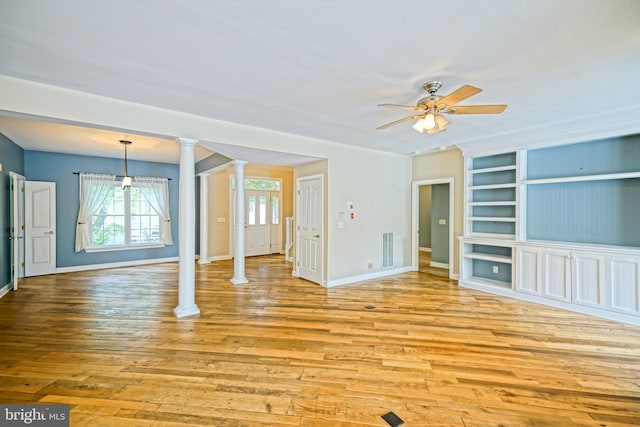 unfurnished living room featuring ceiling fan, light hardwood / wood-style floors, and decorative columns