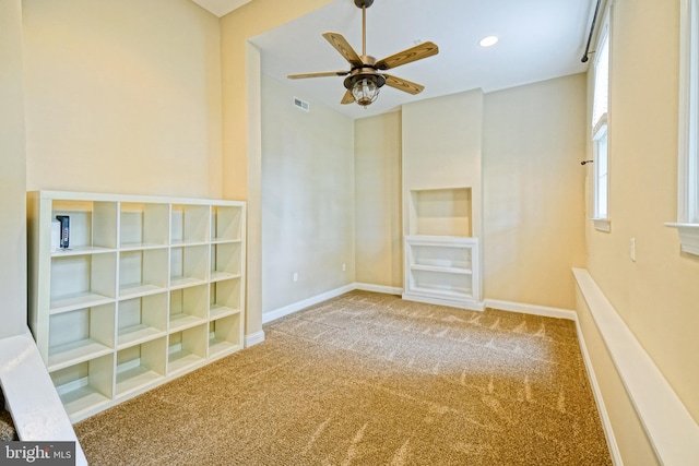 carpeted empty room featuring ceiling fan