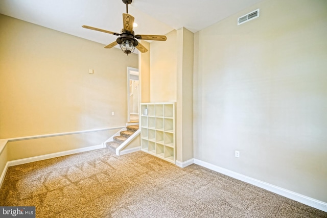 empty room featuring ceiling fan and carpet flooring