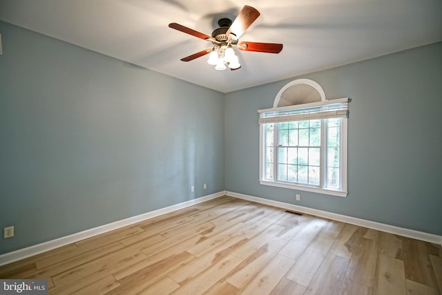 empty room featuring ceiling fan and light hardwood / wood-style floors